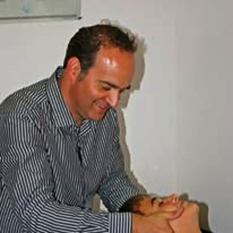 Dr. Najarian performing a chiropractic treatment on a patient