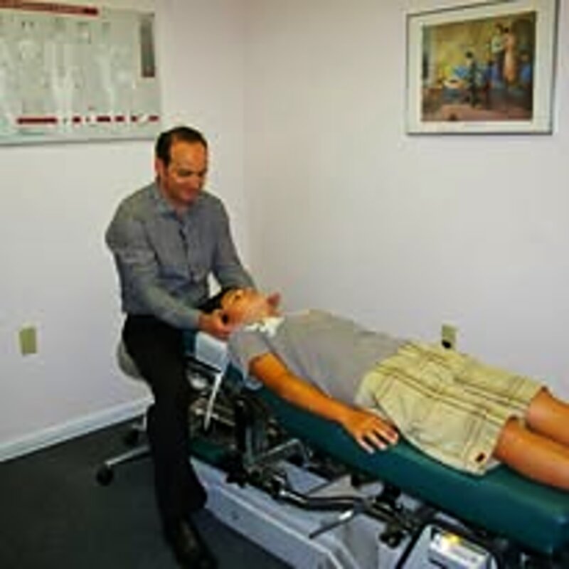 Dr. Najarian performing a spinal adjustment on the treatment table